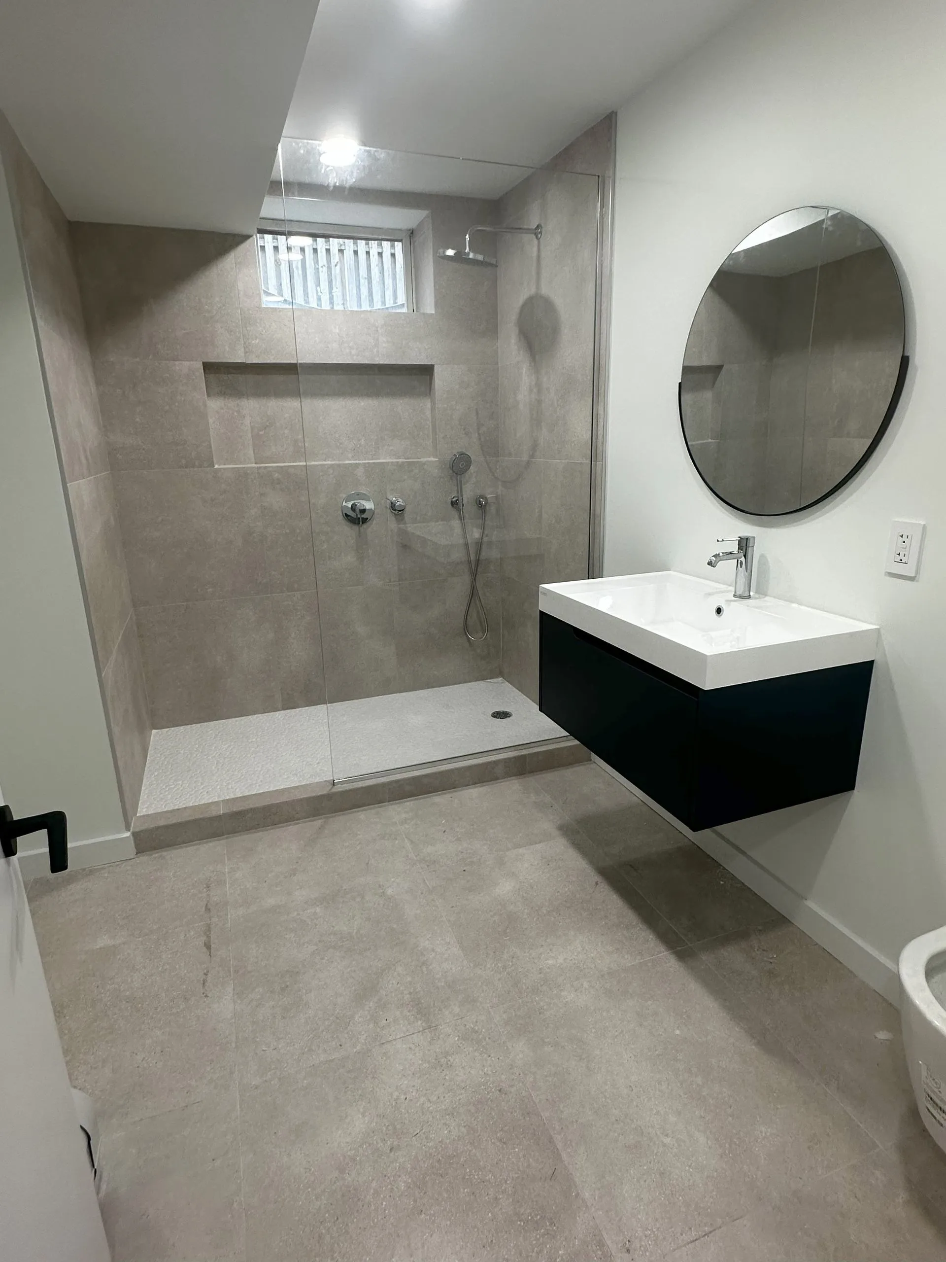 Walk-in shower with stone tile and floating vanity - Northern Bergen County bathroom remodel